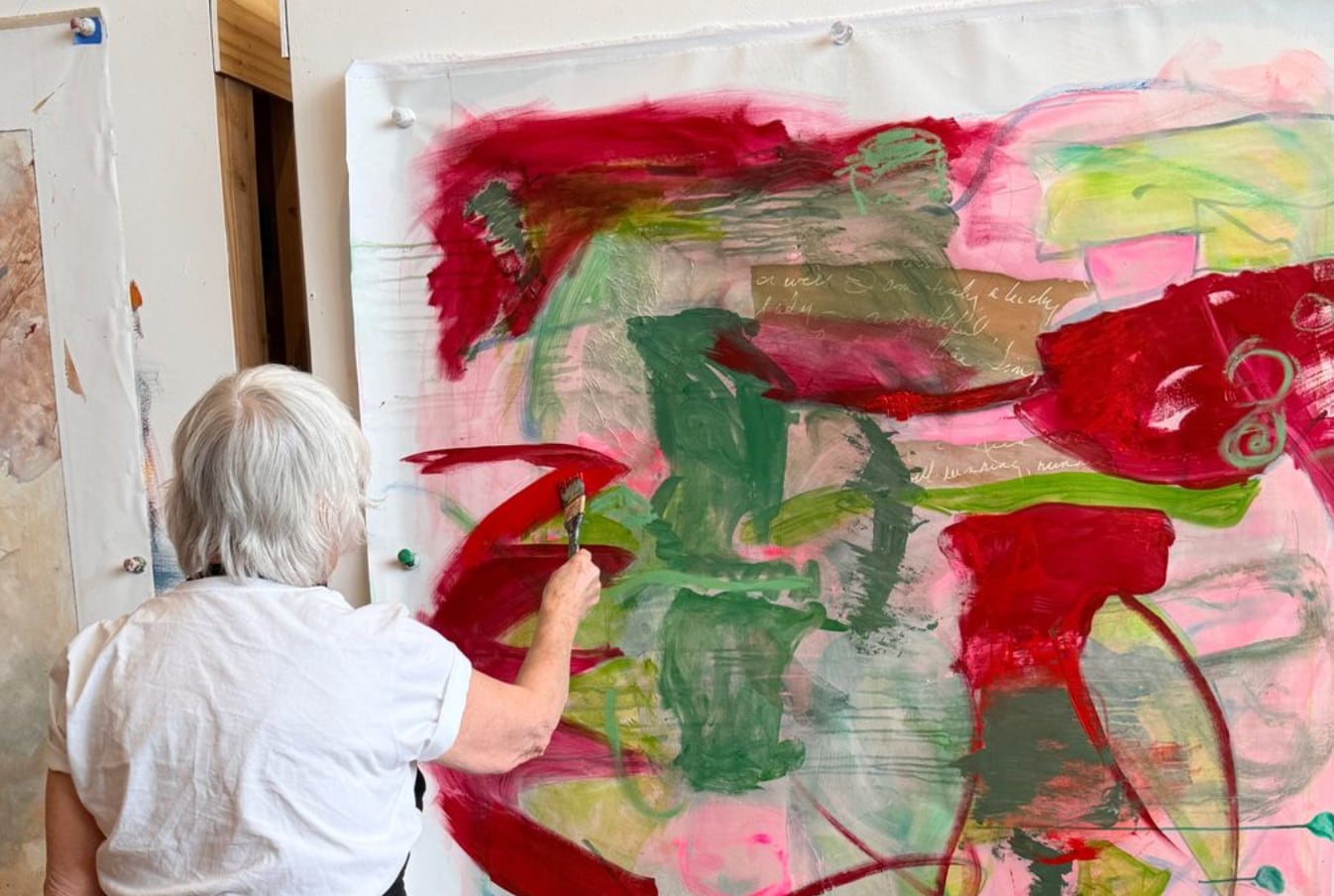 Nancy Junkin painting a large abstract canvas